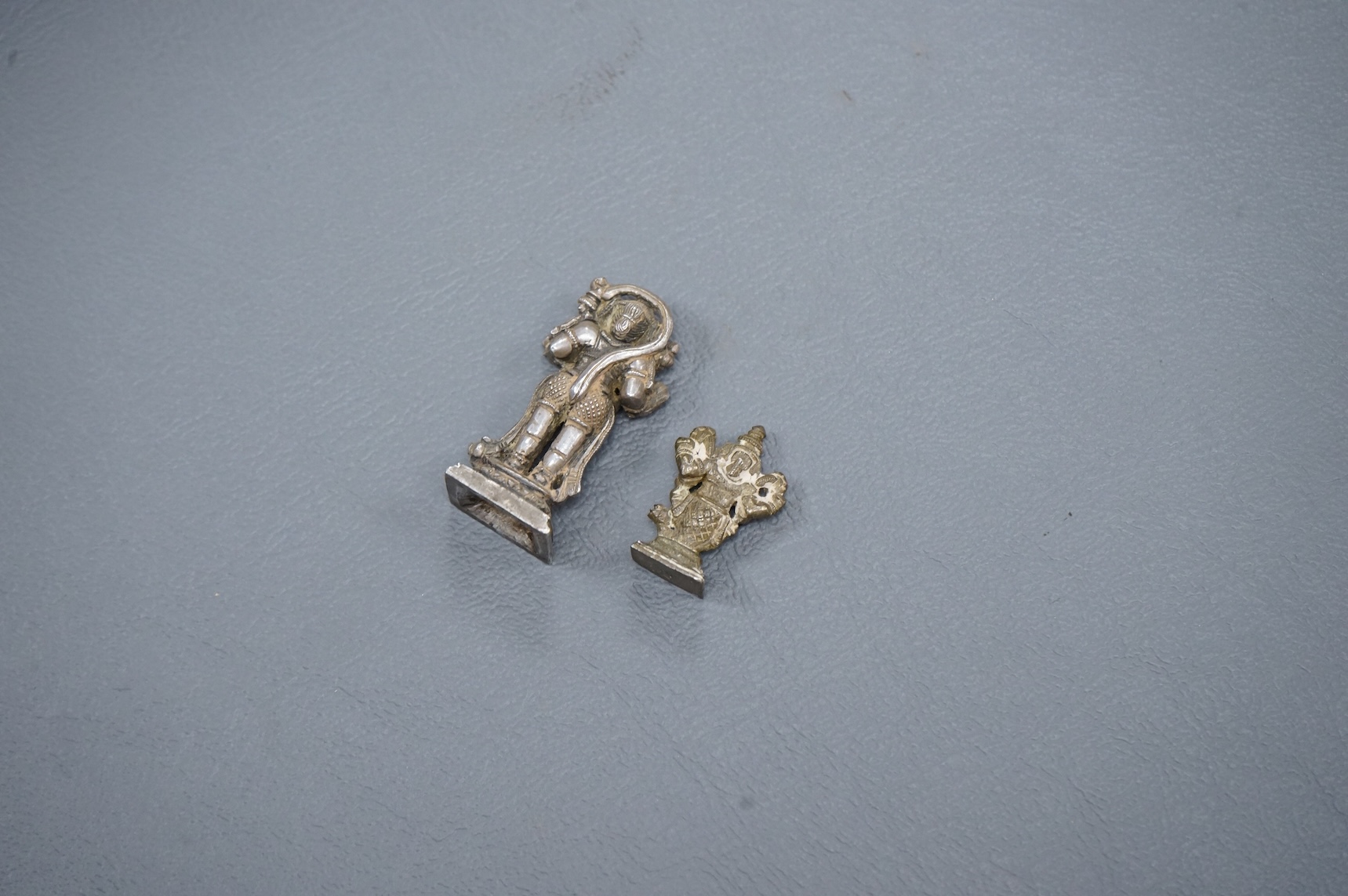 Two small Hindu statuettes, Hanuman (monkey), possibly silver, and Matsya (figure with fish tail), possibly late 19th/early 20th century, largest 3.5cm high